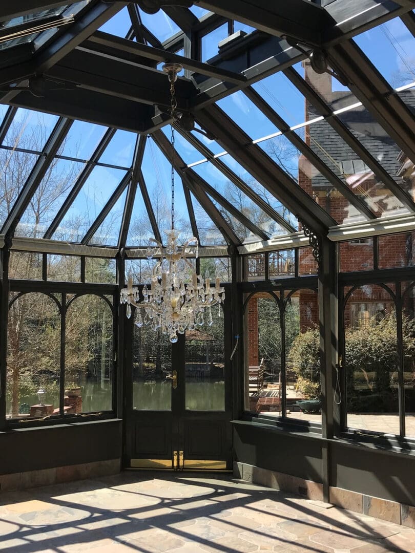 A large glass building with many windows and a chandelier.