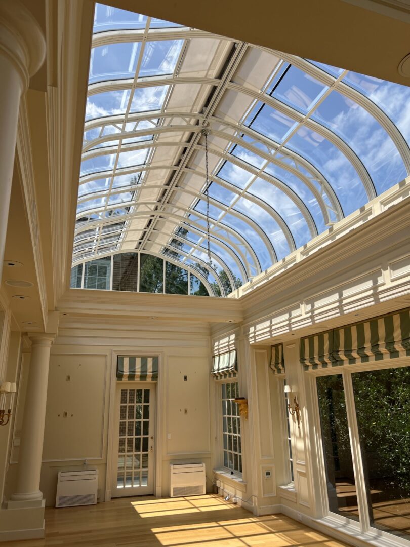 A large room with a skylight and many windows.