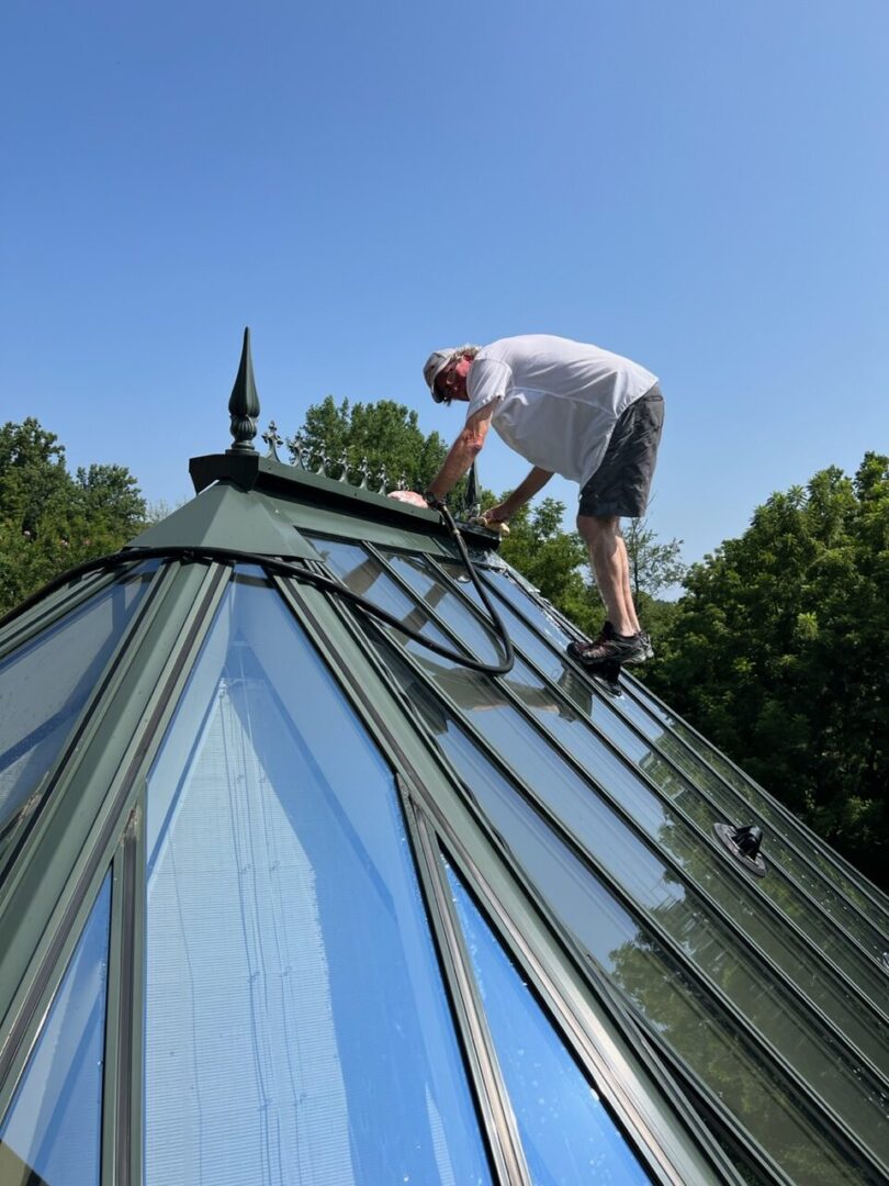 A man on top of a green roof.