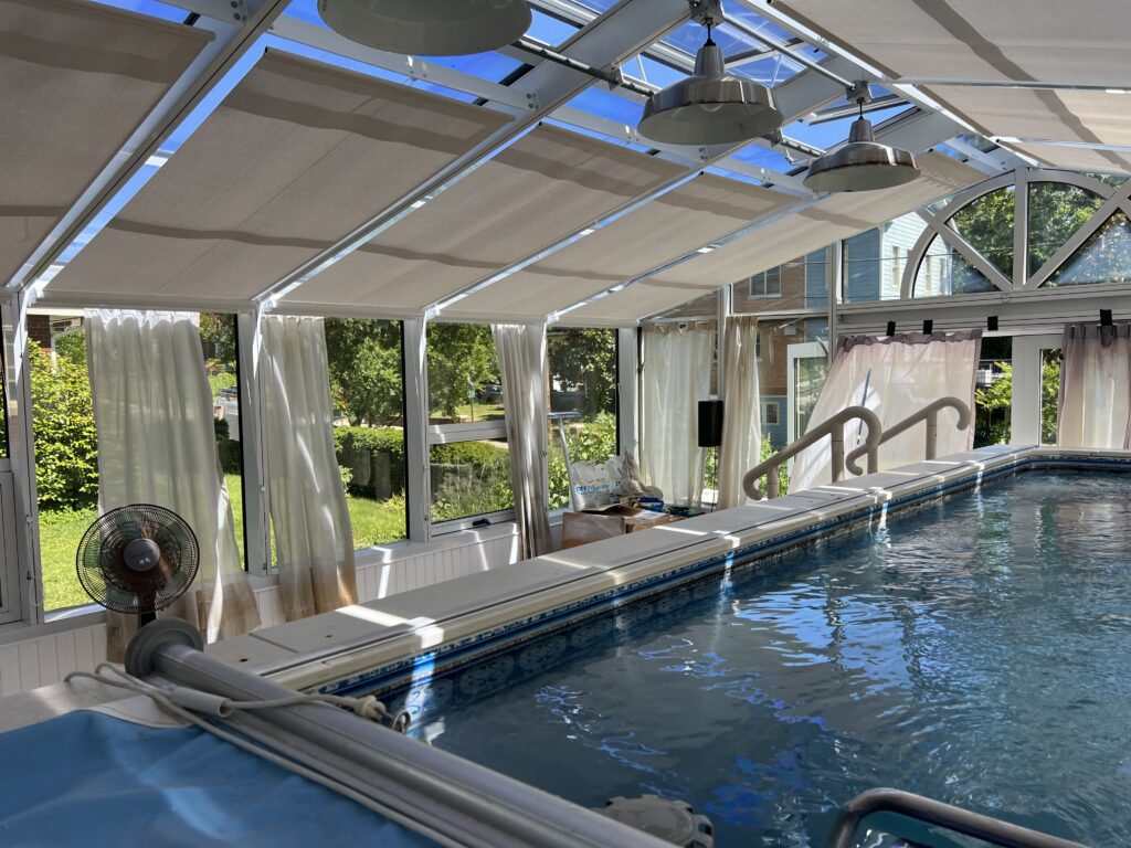 A pool with a slide and some curtains