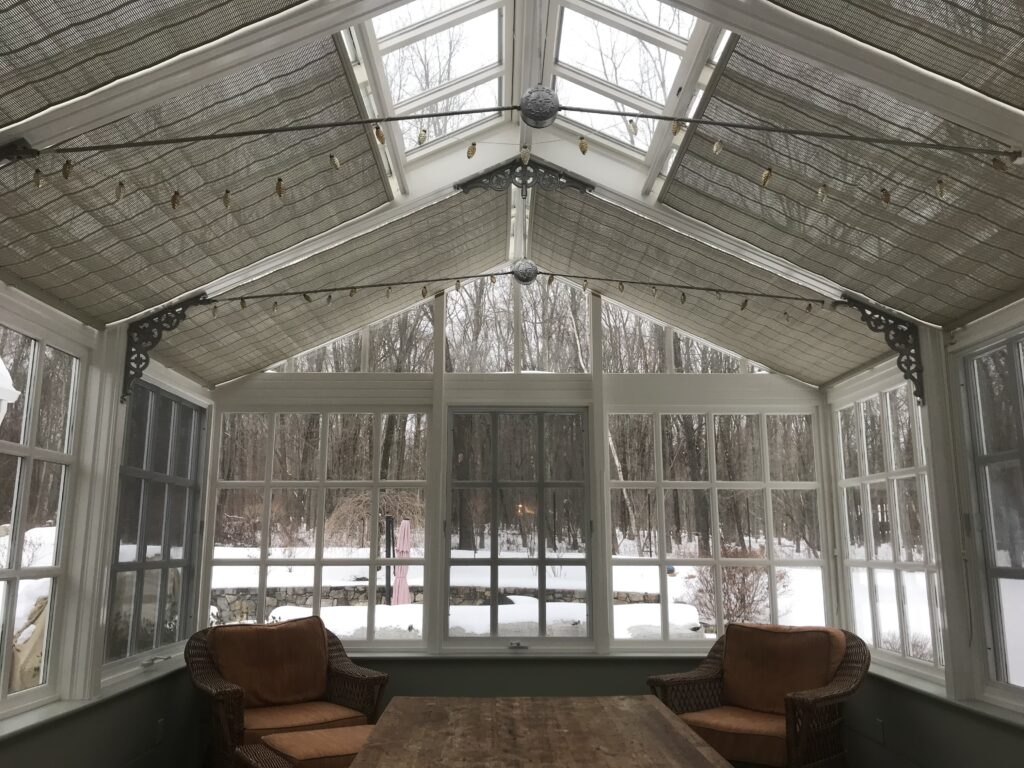 A room with two brown chairs and a table